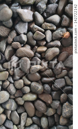 Texture of smooth wet river stones and dark pebbles for spa and garden design Texture of smooth wet river stones and dark pebbles for spa and garden design 142722142