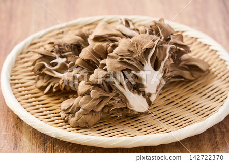Raw maitake mushrooms served on a bamboo basket. Raw maitake mushrooms served on a bamboo basket. 142722370