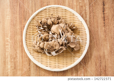 Raw maitake mushrooms served on a bamboo basket. Raw maitake mushrooms served on a bamboo basket. 142722371