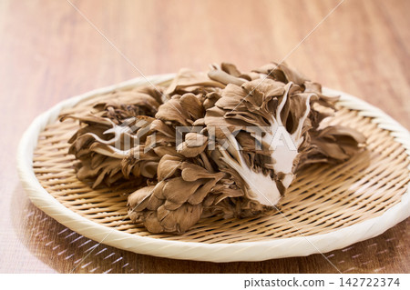 Raw maitake mushrooms served on a bamboo basket. Raw maitake mushrooms served on a bamboo basket. 142722374
