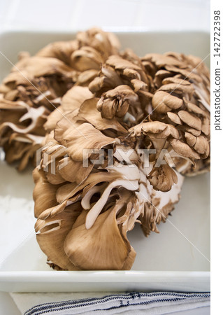 Fresh maitake mushrooms, mushroom ingredients being prepared. Fresh maitake mushrooms, mushroom ingredients being prepared. 142722398