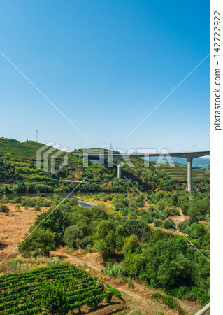 Tall concrete bridge over Tua river in Douro valley 142722922