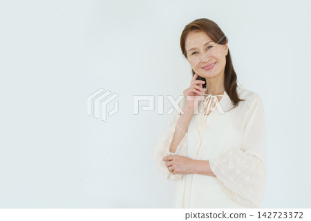 Portrait of a senior Japanese woman against a white background Portrait of a senior Japanese woman against a white background 142723372