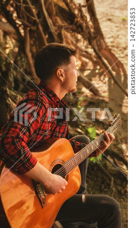 Musician Playing Acoustic Guitar under Tree Musician Playing Acoustic Guitar under Tree 142723853