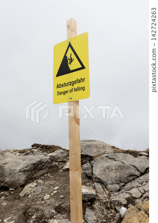 Warning sign: Danger of rockfall in the mountains Warning sign: Danger of rockfall in the mountains 142724263