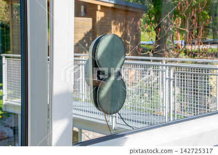 Automatic window cleaning robot attached to exterior glass surface Automatic window cleaning robot attached to exterior glass surface 142725317