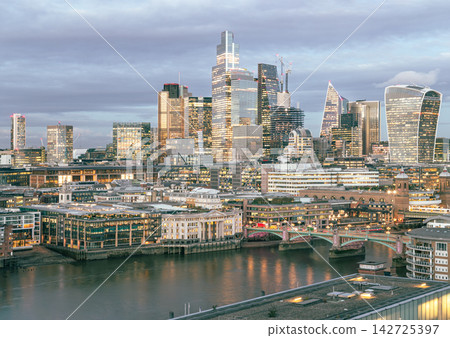 The City of London skyline emerges as a stunning architectural tapestry, where the soaring, glass-clad peaks of 22 Bishopsgate and the "Walkie Talkie" catch the honeyed warmth of the setting sun. The City of London skyline emerges as a stunning architectural tapestry, where the soaring, glass-clad peaks of 22 Bishopsgate and the "Walkie Talkie" catch the honeyed warmth of the setting sun. 142725397