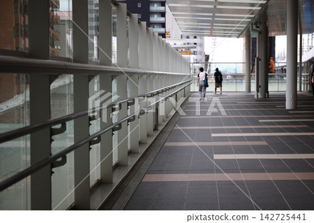 People walking on the pedestrian deck People walking on the pedestrian deck 142725441