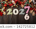 Christmas Ornaments and 2027 Numbers on Wooden Table 142725812
