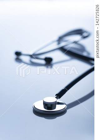 Healthcare medical background of backlit stethoscope laying on table with copy-space Healthcare medical background of backlit stethoscope laying on table with copy-space 142725826