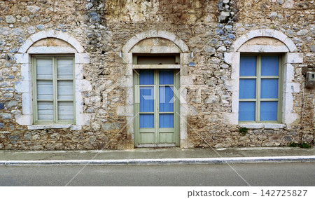 old windows on the wall of the old house old windows on the wall of the old house 142725827