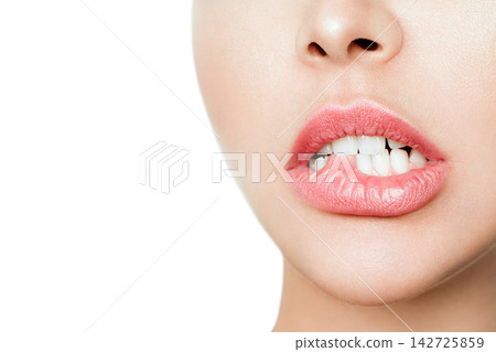 Close-Up of Beautiful Lips with Lipstick and Biting Lip Close-Up of Beautiful Lips with Lipstick and Biting Lip 142725859