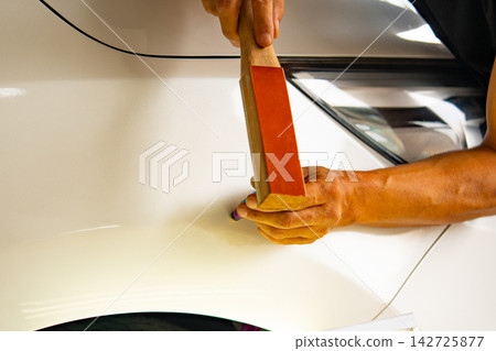 Removing dents on the car. PDR technology. Car body repair without painting. Removing dents on the car. PDR technology. Car body repair without painting. 142725877