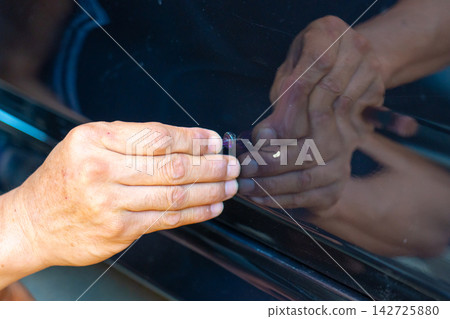 Removing dents on the car. PDR technology. Car body repair without painting. Removing dents on the car. PDR technology. Car body repair without painting. 142725880