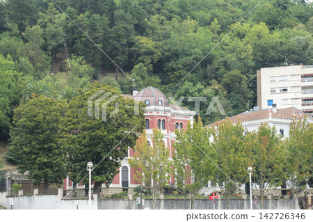 Red villa with a tiled dome on the wooded hillside above Bilbao, Spain Red villa with a tiled dome on the wooded hillside above Bilbao, Spain 142726346