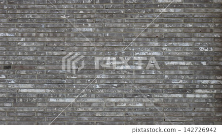 Loft style masonry featuring narrow, elongated bricks. The texture is heavily weathered and rough, characterized by pronounced white efflorescence and areas of abrasion against a grey background Loft style masonry featuring narrow, elongated bricks. The texture is heavily weathered and rough, characterized by pronounced white efflorescence and areas of abrasion against a grey background 142726942