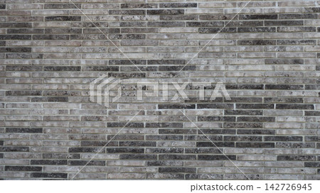 A section of a modern brick wall made of narrow, elongated bricks. A section of a modern brick wall made of narrow, elongated bricks. 142726945