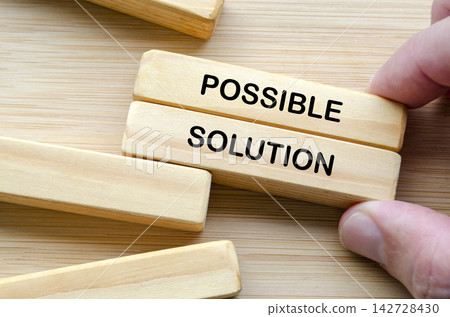 Hand holding wooden blocks representing structured problem solving with possible solution Hand holding wooden blocks representing structured problem solving with possible solution 142728430