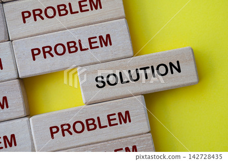 Top view of solution text on wooden block with representing solution to problems 142728435