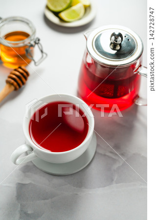 Warm berry tea with honey, lemon and lime, cozy autumnal drink 142728747