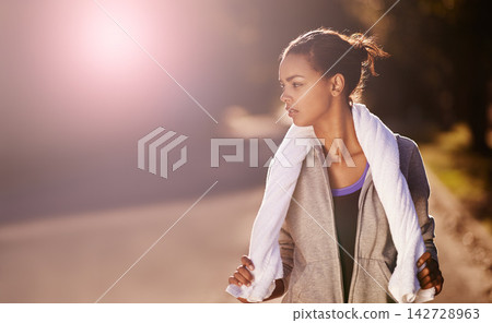 Fitness, night and running with woman on street of neighborhood for cardio training or workout. Exercise, thinking and towel with athlete or runner outdoor in evening for marathon or wellness 142728963