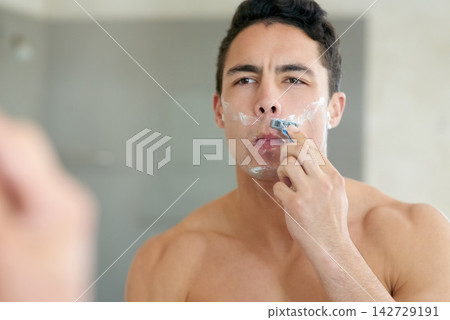 Man, bathroom and shaving beard in mirror with blade for hygiene and fresh skin with hair removal. Skincare, grooming and home with cream or soap for facial or wellness, self care and routine Man, bathroom and shaving beard in mirror with blade for hygiene and fresh skin with hair removal. Skincare, grooming and home with cream or soap for facial or wellness, self care and routine 142729191