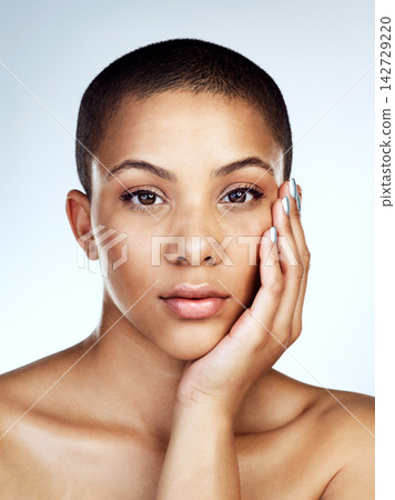 Beauty, portrait and skin of natural black woman in studio on blue background for aesthetic wellness. Cosmetics, face and skincare with confident model for dermatology, foundation or vitamin c Beauty, portrait and skin of natural black woman in studio on blue background for aesthetic wellness. Cosmetics, face and skincare with confident model for dermatology, foundation or vitamin c 142729220