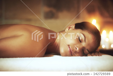 Woman, relax and zen in spa on massage bed for glow, wellness and cosmetics with candles. Treatment, beauty and sleep with peace after aromatherapy, deep tissue and stress relief with oil for luxury Woman, relax and zen in spa on massage bed for glow, wellness and cosmetics with candles. Treatment, beauty and sleep with peace after aromatherapy, deep tissue and stress relief with oil for luxury 142729389