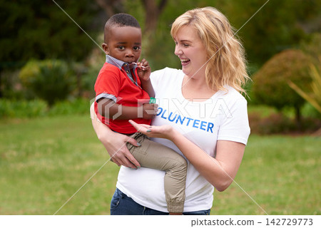 Woman, child and volunteering at charity for kids, community service and outreach program in park. Diversity, help and female missionary with kindness, support and orphan with care for adoption Woman, child and volunteering at charity for kids, community service and outreach program in park. Diversity, help and female missionary with kindness, support and orphan with care for adoption 142729773