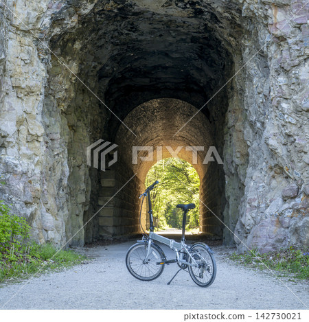 Folding bike on Katy Trail at a tunnel near Rocheport, Missouri, spring scenery. The Katy Trail is 237 mile bike trail converted from an old railroad. 142730021