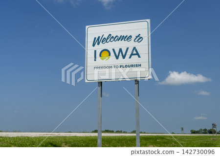Welcome to Iowa - roadside sign against blue sky at state border with Missouri, travel concept Welcome to Iowa - roadside sign against blue sky at state border with Missouri, travel concept 142730096