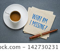 What Am I Missing? Thought provoking handwritten question on a napkin with coffee and pen, encouraging self-reflection, awareness, curiosity, and personal growth. 142730231
