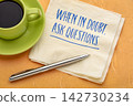 When in Doubt, Ask Questions. Inspirational handwritten message on a napkin with coffee and pen, encouraging curiosity, critical thinking, learning, and better decisions. 142730234