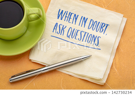 When in Doubt, Ask Questions. Inspirational handwritten message on a napkin with coffee and pen, encouraging curiosity, critical thinking, learning, and better decisions. When in Doubt, Ask Questions. Inspirational handwritten message on a napkin with coffee and pen, encouraging curiosity, critical thinking, learning, and better decisions. 142730234