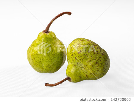 Two green pears with brown speckles and stems on white background, close up with soft lighting and shallow depth of field Two green pears with brown speckles and stems on white background, close up with soft lighting and shallow depth of field 142730903