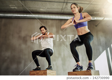 Jumping, man and woman in gym with box, fitness and power training at workout challenge together. Couple, sports club and personal trainer with balance, muscle development and healthy body exercise Jumping, man and woman in gym with box, fitness and power training at workout challenge together. Couple, sports club and personal trainer with balance, muscle development and healthy body exercise 142730990