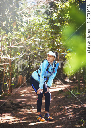 Tired, runner and woman hiking in woods on trail or outdoor adventure to explore on holiday vacation. Girl, rest break or hiker trekking in nature for running training, fitness or travel with fatigue Tired, runner and woman hiking in woods on trail or outdoor adventure to explore on holiday vacation. Girl, rest break or hiker trekking in nature for running training, fitness or travel with fatigue 142731058