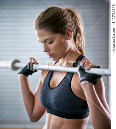 Fitness, health and woman with barbell training for weight lifting and muscle endurance for competition. Sports, female bodybuilder and athlete in gym for commitment and discipline to exercise goal Fitness, health and woman with barbell training for weight lifting and muscle endurance for competition. Sports, female bodybuilder and athlete in gym for commitment and discipline to exercise goal 142731128