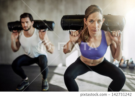 People, squat and sandbag workout or gym training with weightlifting for muscle growth, glutes or bodybuilding. Man, woman and personal trainer with equipment as athlete team, sports or discipline People, squat and sandbag workout or gym training with weightlifting for muscle growth, glutes or bodybuilding. Man, woman and personal trainer with equipment as athlete team, sports or discipline 142731242