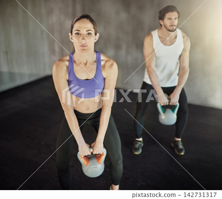 Man, woman and kettlebell workout for weightlifting routine or muscle building, fitness or exercise. Friends, equipment and athlete training in gym centre for strength development, health or sports 142731317