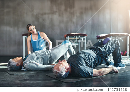 Woman, senior people and medicine ball in gym for health, wellness and exercise. Physiotherapist or trainer, couple and equipment in fitness centre for retirement, rehabilitation and physical therapy Woman, senior people and medicine ball in gym for health, wellness and exercise. Physiotherapist or trainer, couple and equipment in fitness centre for retirement, rehabilitation and physical therapy 142731318