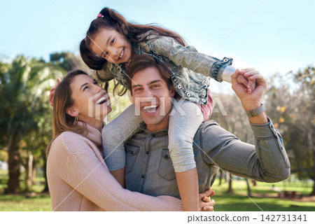 Family, parents and girl in park for piggyback, playing and bonding together with smile. Happy people, mother and father with child outdoor in nature for relaxing, recreation or physical activity 142731341