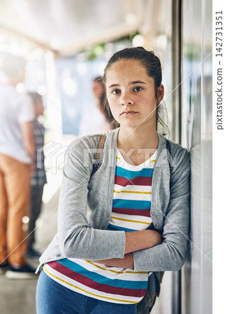 Young girl, portrait and lonely at school with classroom in learning academy or institute. Female person, teenager or learner leaning on wall alone with arms crossed at outdoor campus or college Young girl, portrait and lonely at school with classroom in learning academy or institute. Female person, teenager or learner leaning on wall alone with arms crossed at outdoor campus or college 142731351