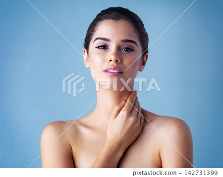 Confidence, cosmetics and portrait of woman with beauty, luxury skincare and face in studio. Dermatology, facial care and proud girl with shine, natural makeup or healthy skin glow on blue background Confidence, cosmetics and portrait of woman with beauty, luxury skincare and face in studio. Dermatology, facial care and proud girl with shine, natural makeup or healthy skin glow on blue background 142731399