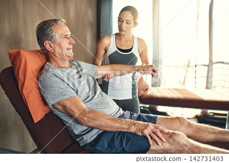 Senior man, physiotherapist and medical in retirement home for healthcare, support for patient with osteoporosis. Male person, physiotherapy and consulting on bed for wellness, help for arthritis Senior man, physiotherapist and medical in retirement home for healthcare, support for patient with osteoporosis. Male person, physiotherapy and consulting on bed for wellness, help for arthritis 142731403