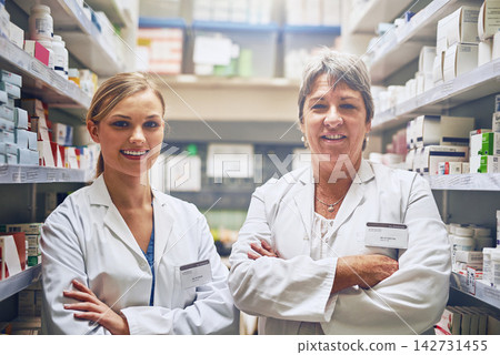 Mentor, pharmacists or portrait of people with arms crossed in healthcare clinic, pharmacy or drugstore. Intern, teamwork or confident women by shelf for safe medication, pills or medicine for trust Mentor, pharmacists or portrait of people with arms crossed in healthcare clinic, pharmacy or drugstore. Intern, teamwork or confident women by shelf for safe medication, pills or medicine for trust 142731455