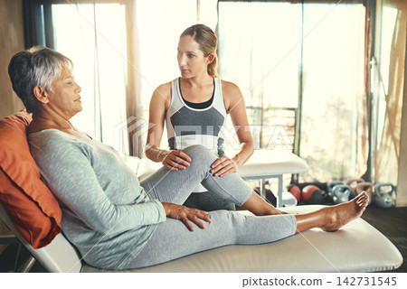 Mature woman, physiotherapist and healthcare in retirement home for medical, support for patient with osteoporosis. Female person, physiotherapy and consulting on bed for wellness, help for arthritis Mature woman, physiotherapist and healthcare in retirement home for medical, support for patient with osteoporosis. Female person, physiotherapy and consulting on bed for wellness, help for arthritis 142731545