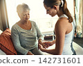 Physiotherapy, health and senior woman with hand massage for arthritis, joint pain and injury recovery in clinic. Physical therapy, chiropractor and healthcare rehabilitation and osteoporosis support 142731601