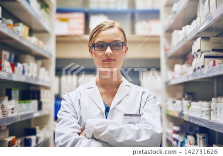 Confident, pharmacist or portrait of woman with arms crossed in pharmacy, healthcare clinic or drugstore. Serious, wellness or proud doctor by shelf for medication, pills or ready to help in service 142731626