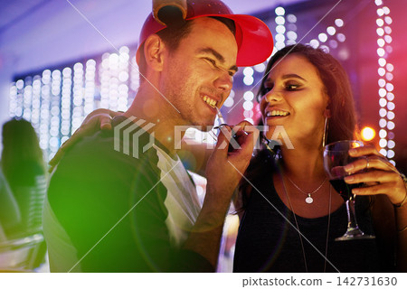 Drinks, lights and couple in nightclub for fun, music or happy weekend at social event. Nightlife, man and woman on date at dance club with wine, smile and friends celebrate together in party culture Drinks, lights and couple in nightclub for fun, music or happy weekend at social event. Nightlife, man and woman on date at dance club with wine, smile and friends celebrate together in party culture 142731630